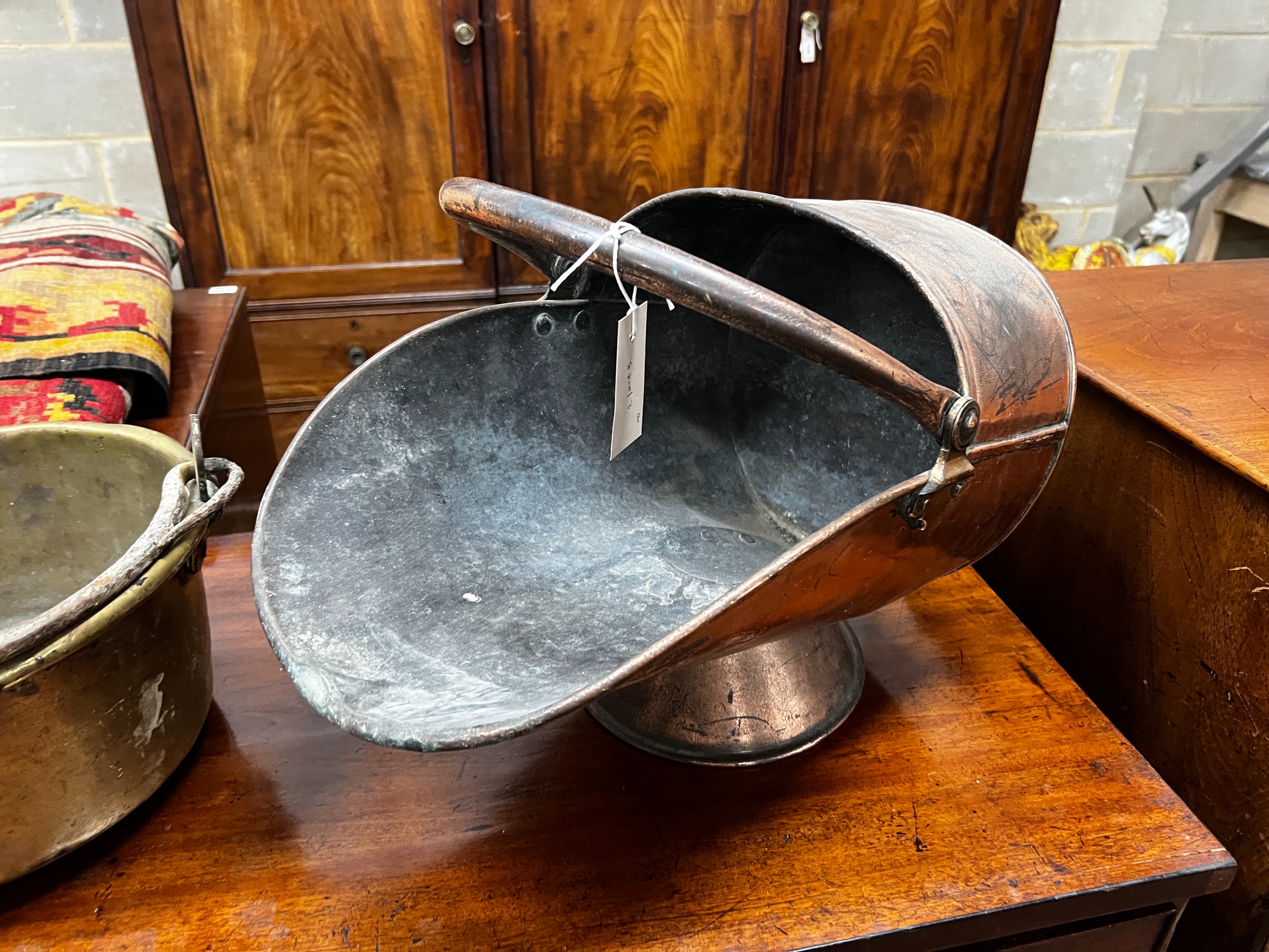 A Victorian copper coal scuttle and a brass preserving pan